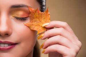Beautiful Woman In With Autumn Dry Leaves